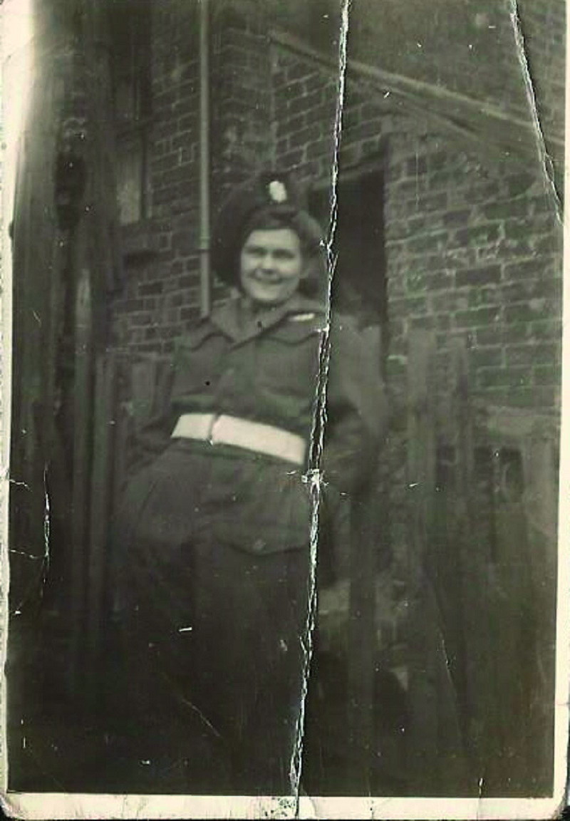 Black and white photograph of a woman wearing a Second World War man's army uniform