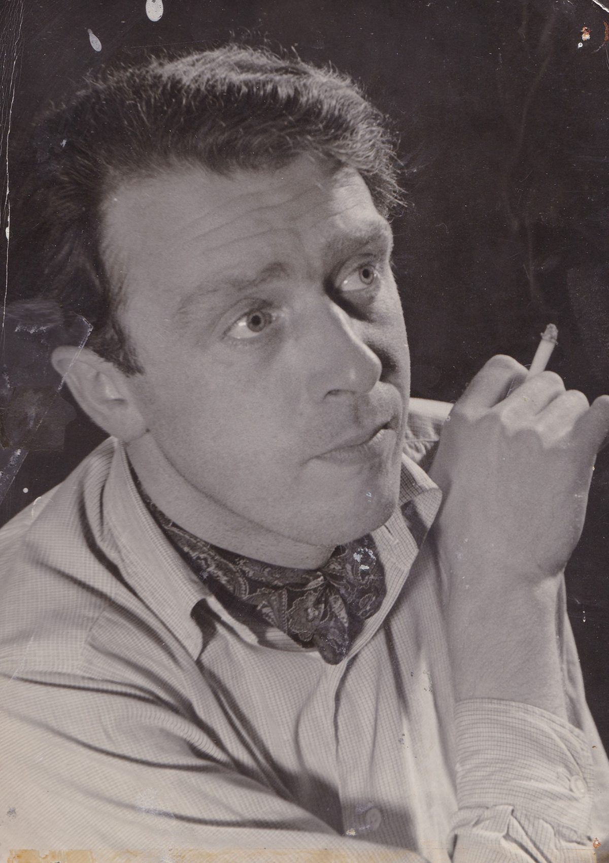 Black and white photograph of Freddie Jones smoking a cigarette