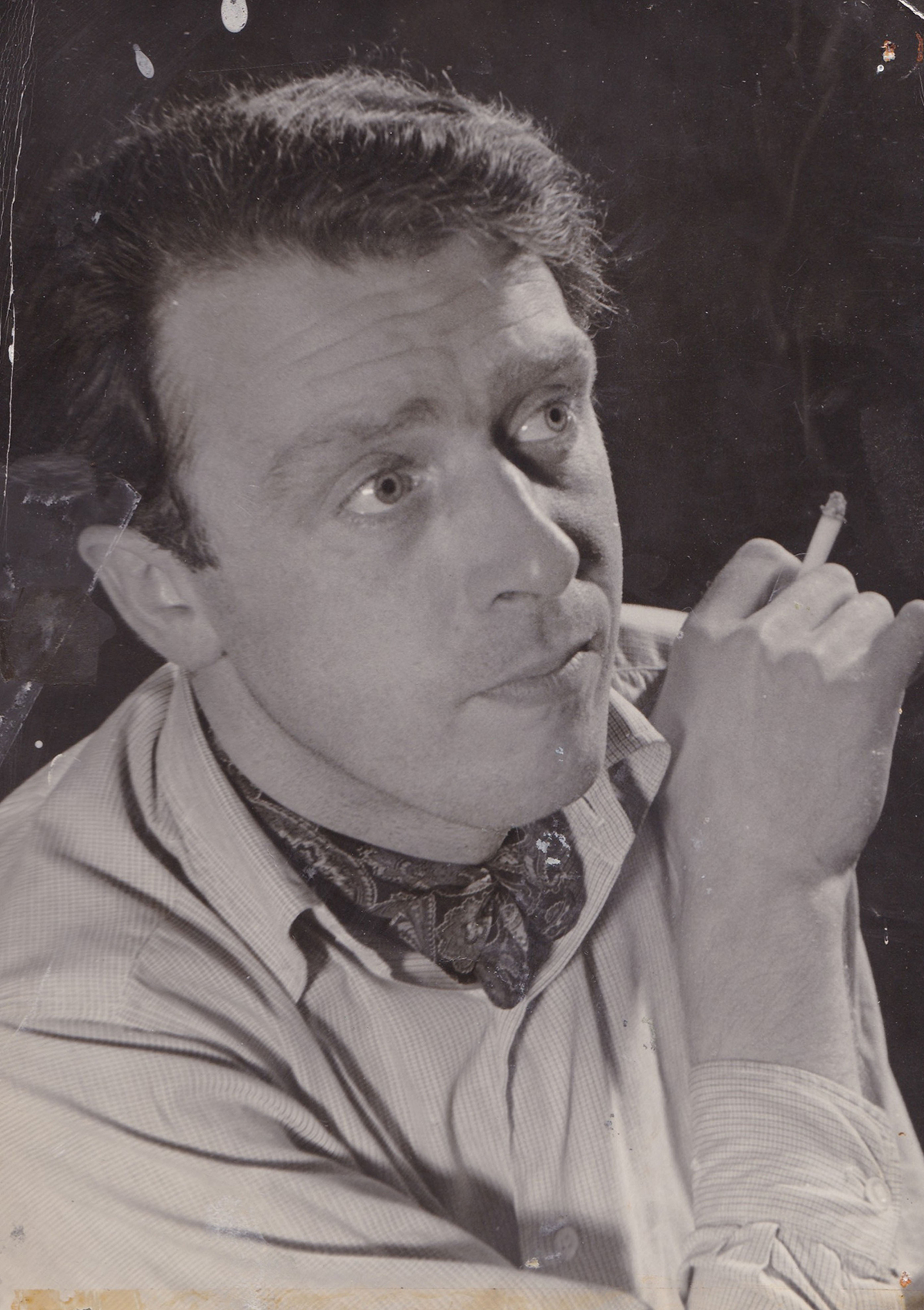 Black and white photograph of Freddie Jones smoking a cigarette