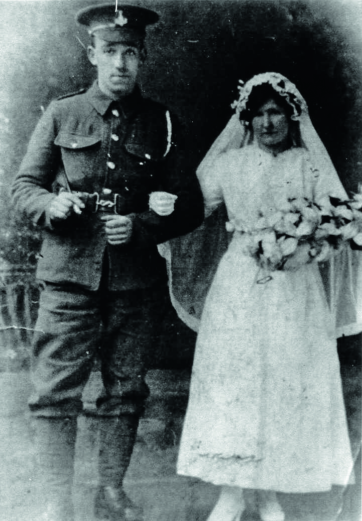 Black and white photograph of a bride and a groom in military uniform