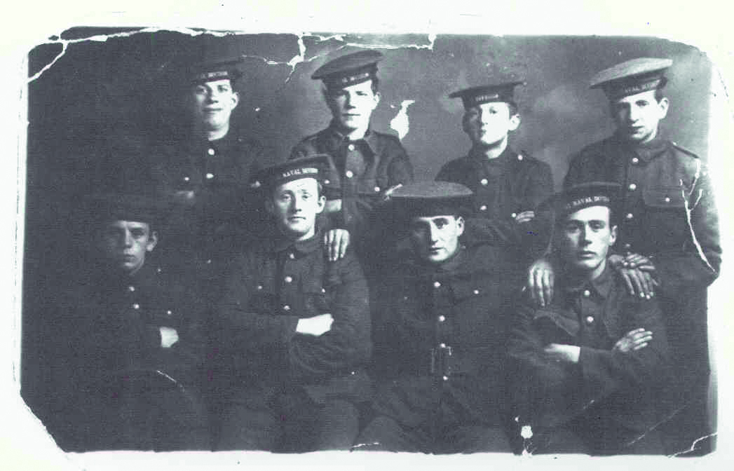 Black and white photograph of eight men in Navy uniforms