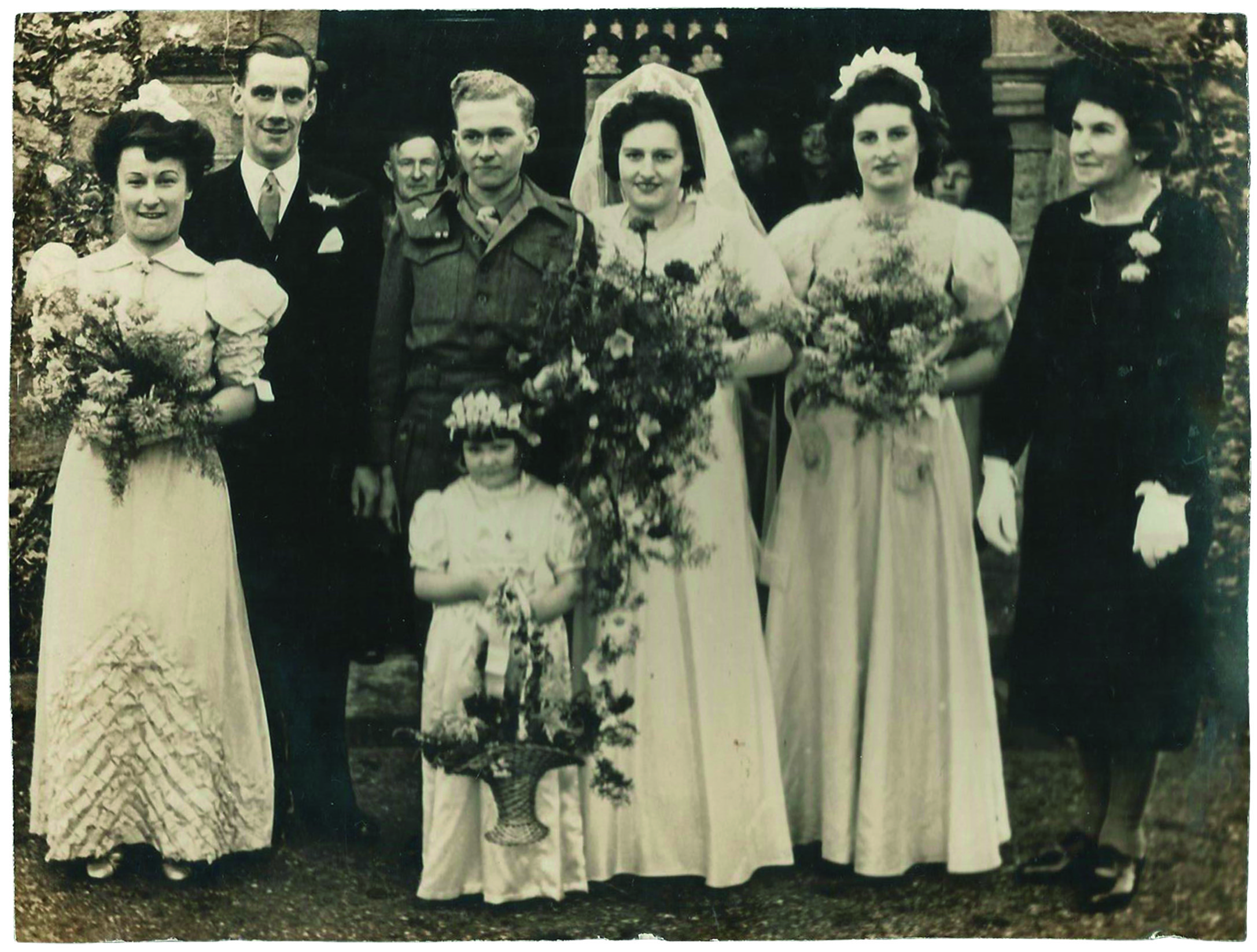 Black and white photograph of a wedding with the groom in a Second World War army uniform