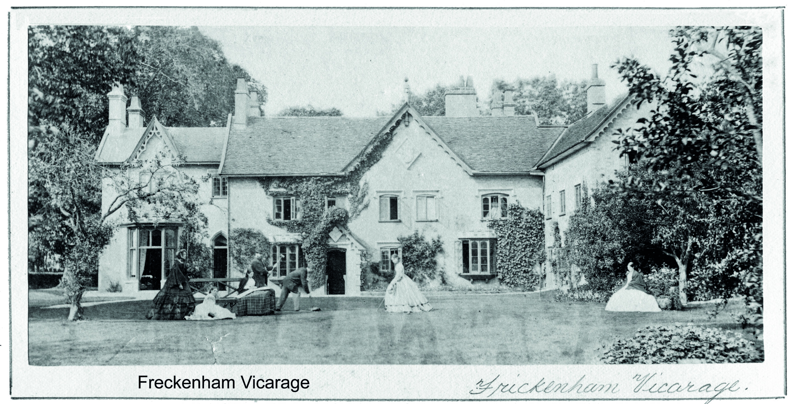 Black and white photograph of a house with women in Victorian dress standing in the garden and the caption 'Freckenham Vicarage'