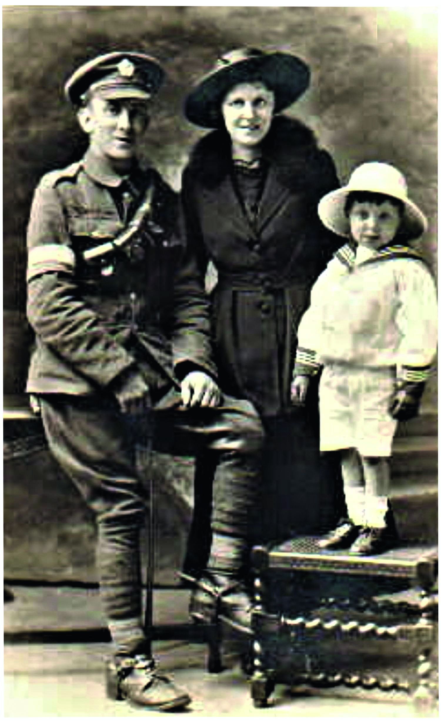 Black and white photograph of a man in First World War army uniform, a woman and a little boy in a sailor suit