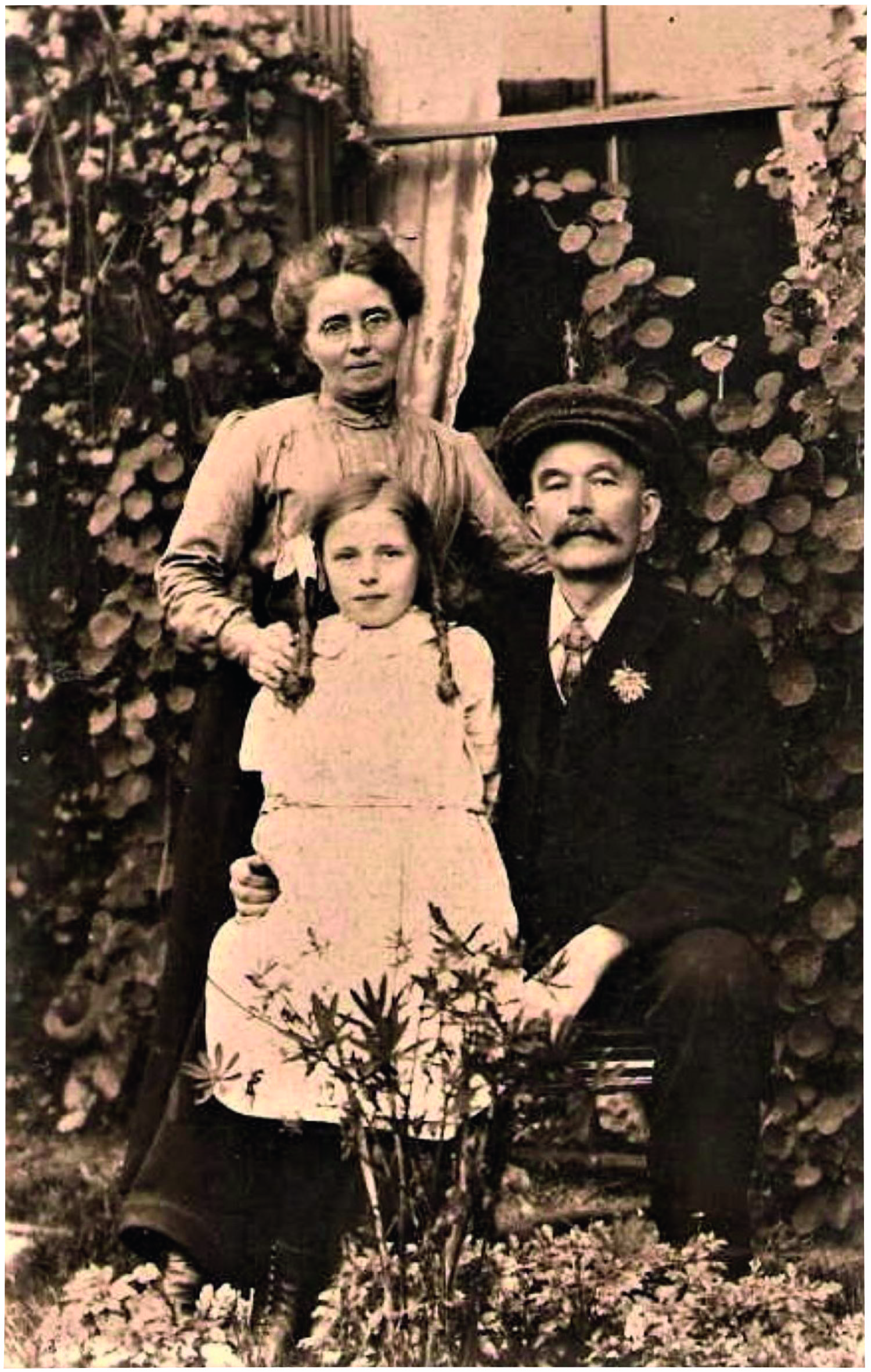 Black and white photograph of a man, a woman and a little girl in Victorian dress