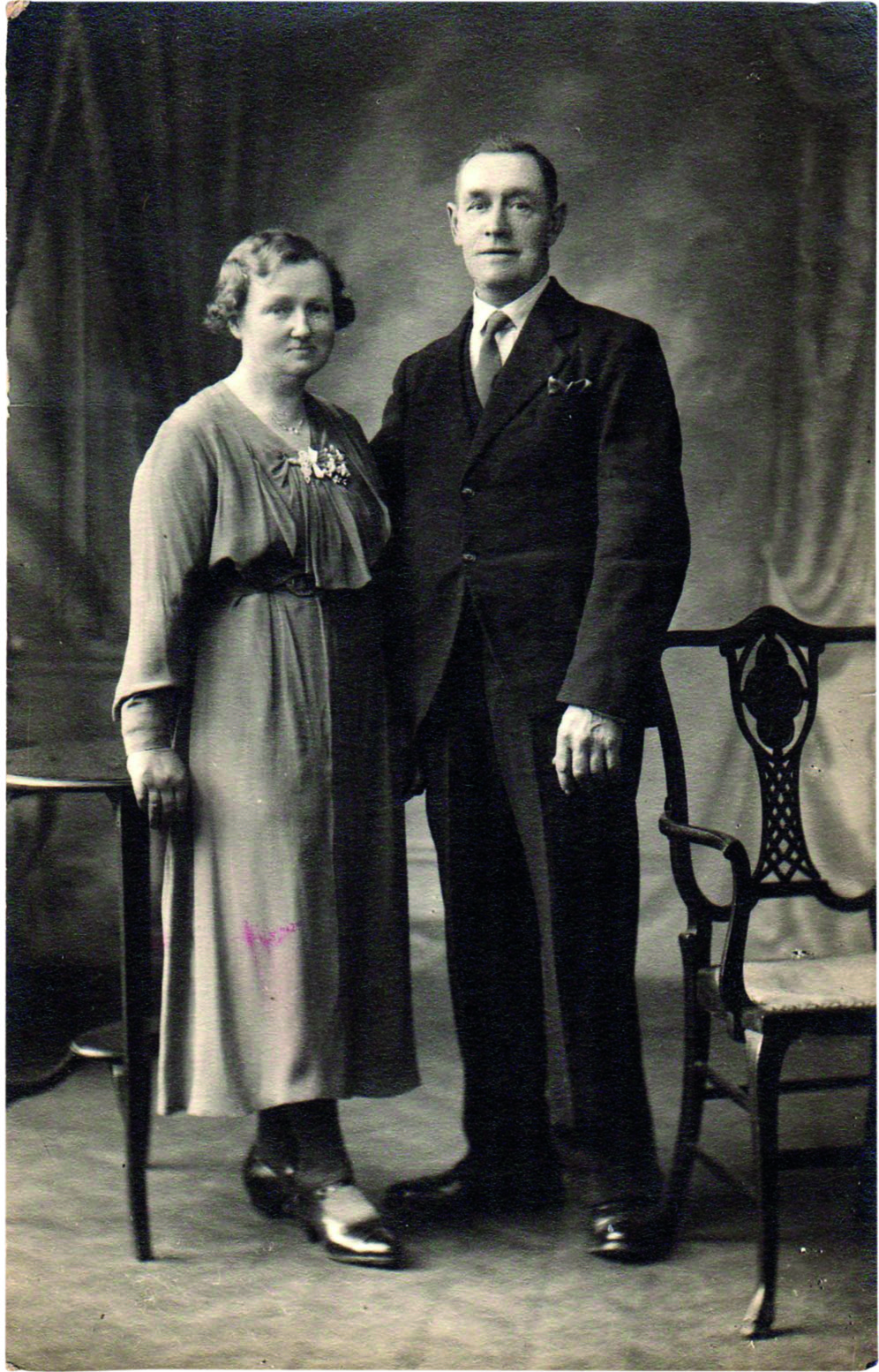 Black and white photograph of a middle-aged man and woman in old-fashioned clothes