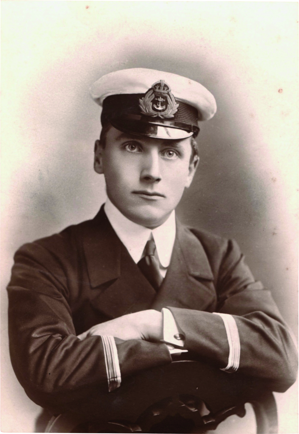 Black and white photograph of a teenage boy in navy uniform